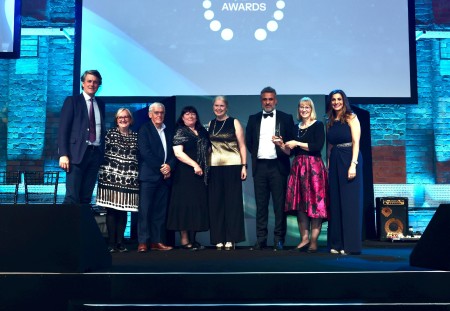 A group of people on stage at an award ceremony.